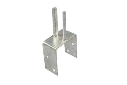 An angled studio shot of a galvanized steel saddle bracket for temporary fencing, highlighting its U-shaped base, anchor holes, and dual vertical mounting pegs designed to straddle concrete barriers.