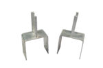 A side-by-side comparison of two galvanized steel Jersey barrier saddle brackets on a white background, showing a dual-peg model on the left and a single-peg model on the right.
