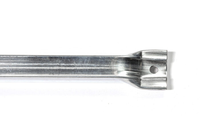 Detailed close-up view of the flattened top connector end of a temporary fence windbrace tube, showing a single pre-drilled hole
