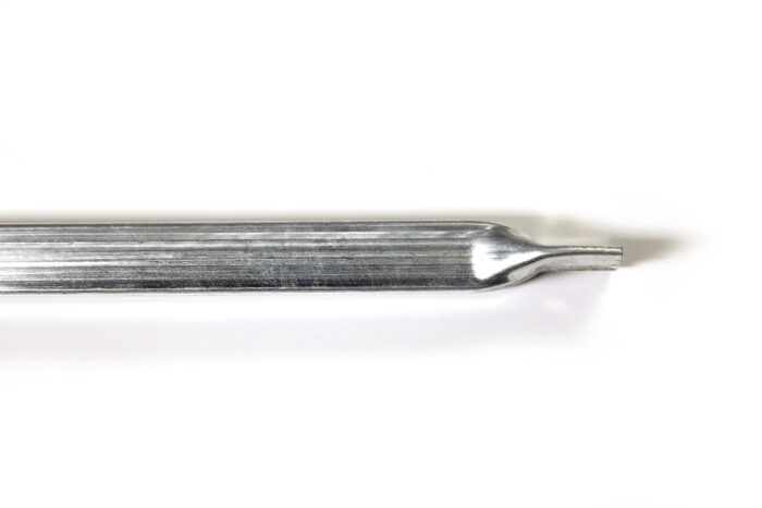 Detailed close-up view of the flattened connector end of a metal windbrace pole, designed to bolt onto a fence panel frame.
