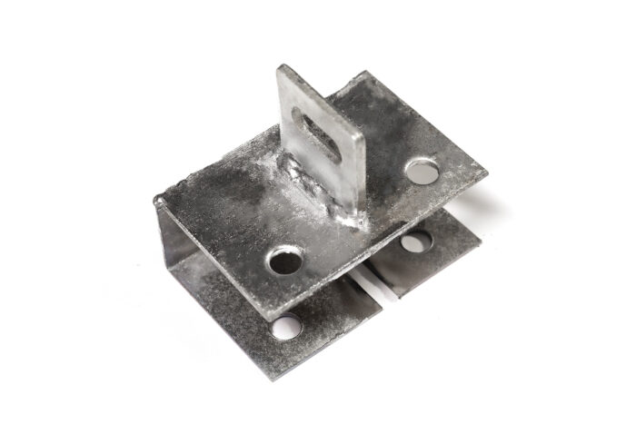 An oblique view of a separate galvanized steel anchor base plate, featuring corner holes and a slotted vertical tab in the center.