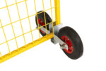 A close-up angle showing the bottom frame of a yellow temporary fence panel slotted into a galvanized wheel assembly with two solid rubber tires and red rims.