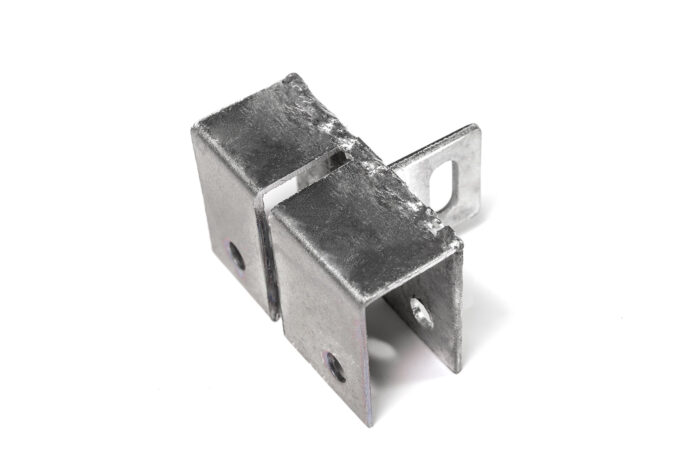 A side profile view of a flat galvanized steel anchoring base, highlighting the profile of the central slotted vertical tab.