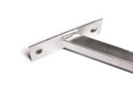 Extreme close-up view focusing on the textured weld seam connecting the vertical slotted tab to the flat galvanized base plate.