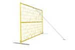 A yellow mesh temporary fence panel installed on flat metal bases and stabilized by a diagonal silver windbrace.